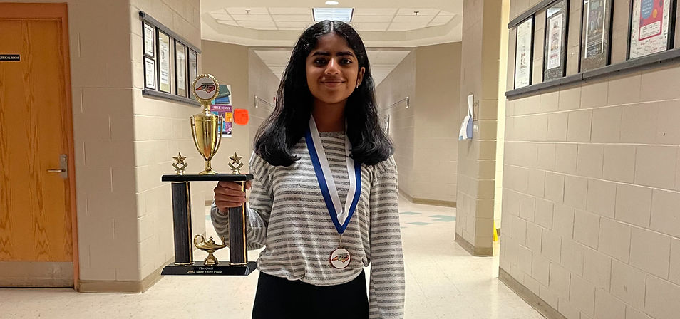 Anvitha with a Quill club trophy